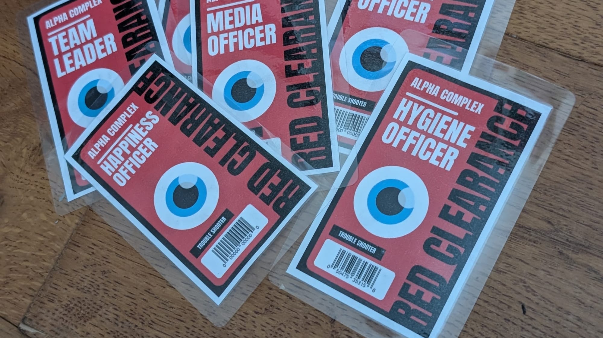My finished Clearance Passes for the Paranoia TTRPG